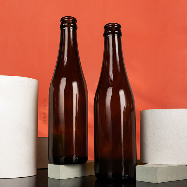 Venta caliente 350 ml Botella de cerveza de vidrio vacío Amber con gorra de corona