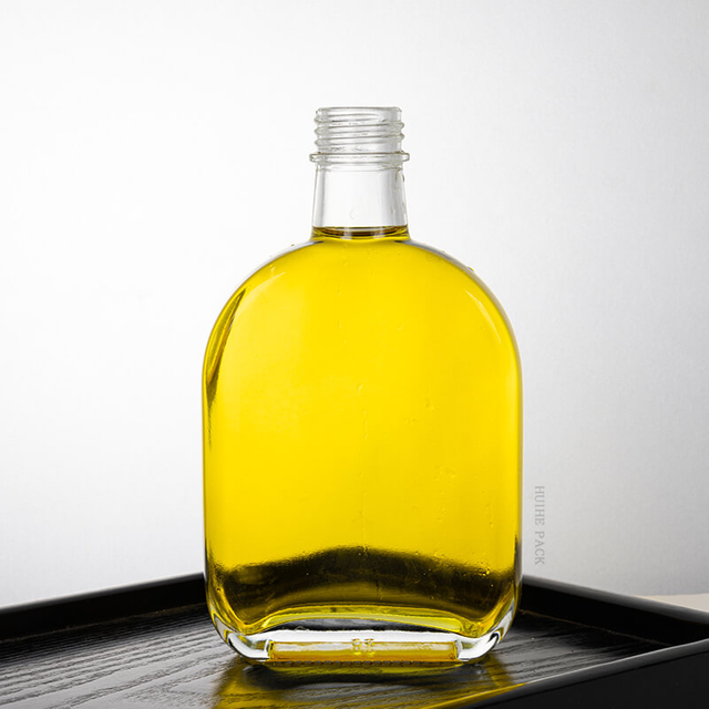 Botella de licor de vidrio claro ovalado con tornillo de tornillo