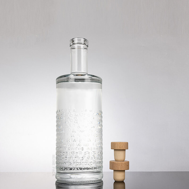 Letras elevadas botella de licor de vidrio de cilindro texturizado