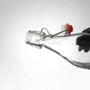 Botella de bebida potable de agua de vidrio transparente de 1000 ml con tapa abatible