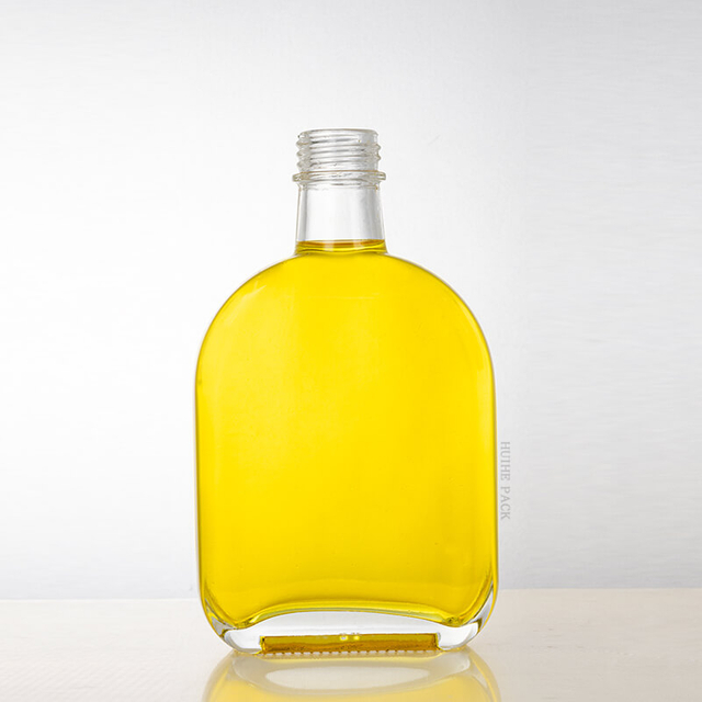 Botella de licor de vidrio claro ovalado con tornillo de tornillo