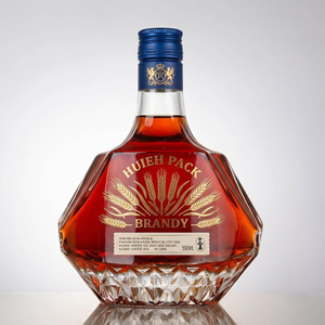 Botella liuqor de vidrio de forma angular con lados facetados